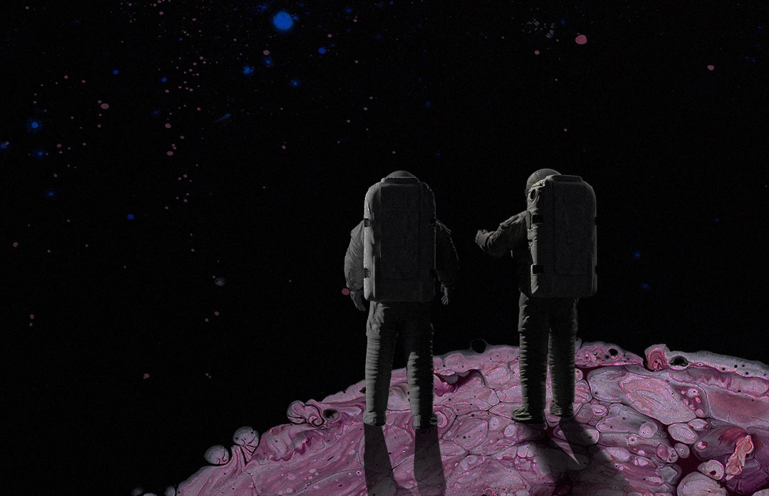 Two astronauts in spacesuits stand on a rocky, marbled pink surface, looking out into a dark star-filled outer space.