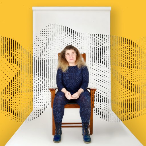 A person sits on a chair against a white backdrop with abstract black dotted patterns, set against a yellow background.