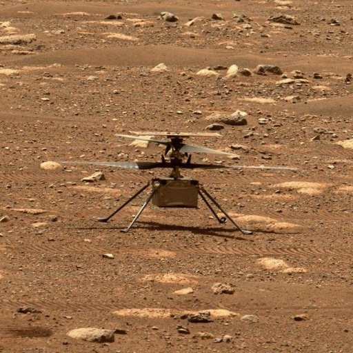 Nasa's ingenuity mars helicopter captured mid-flight on the martian surface, surrounded by rocky terrain.