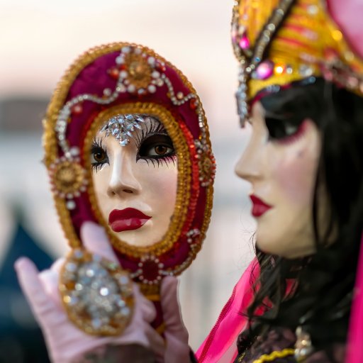 A woman in a pink mask is holding a Nietzsche mirror.