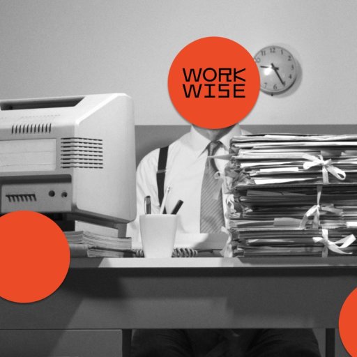 A person sits at a cluttered desk with a large stack of files, an old printer, and office supplies; their face is covered by an orange circle labeled "WORK WISE.