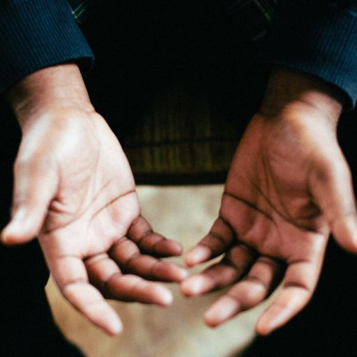 A close up of a man's hands palms facing up.