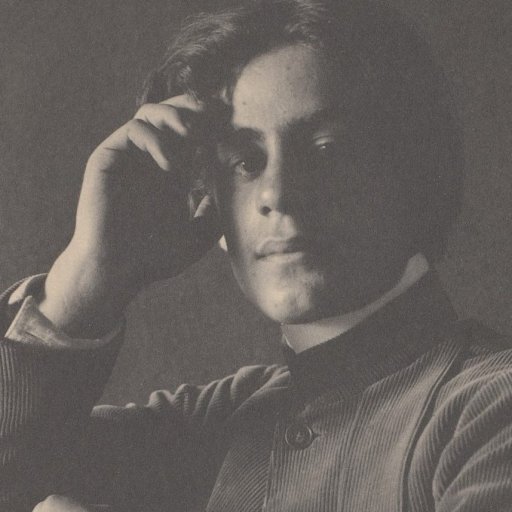 A black and white photo of a man with his hand on his head.