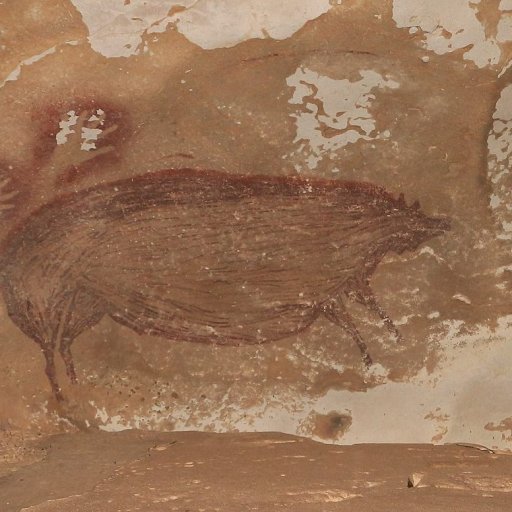 Ancient cave painting depicting animal figures, including what appears to be a bull and a bird, on a textured, brown and beige rock surface.