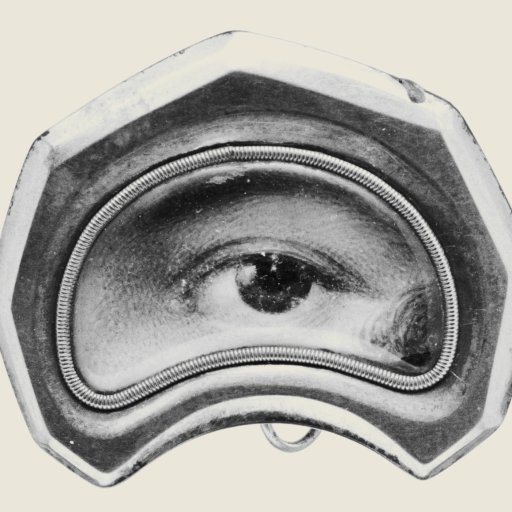 A vintage, hexagonal brooch featuring a realistic painted human eye in the center, surrounded by a metallic frame.