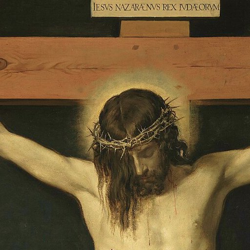 Painting depicting a man with a crown of thorns, arms outstretched on a wooden cross, with a sign above his head that reads "Iesus Nazarenus Rex Iudaeorum.