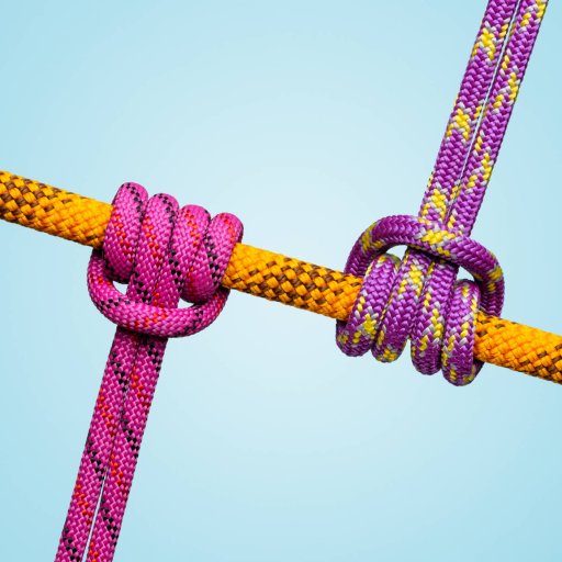 Three colorful ropes tied in knots against a light blue background symbolize workplace friction.