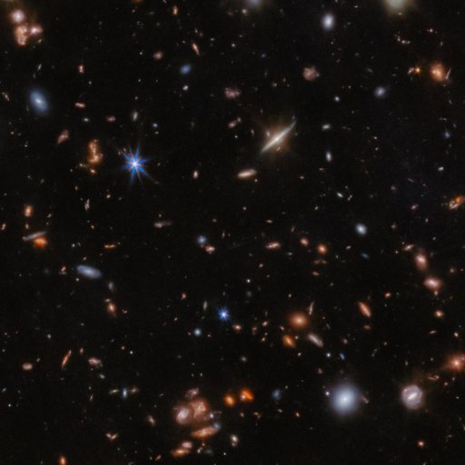 A deep space image showing numerous distant galaxies of various shapes and sizes scattered across a dark background, revealing just how empty is space between these cosmic islands.