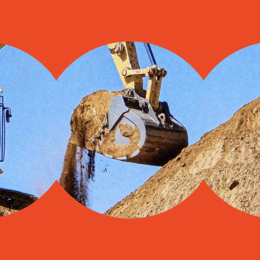 A construction excavator lifts and dumps dirt from a large mound against a clear blue sky, framed by a circular red border.